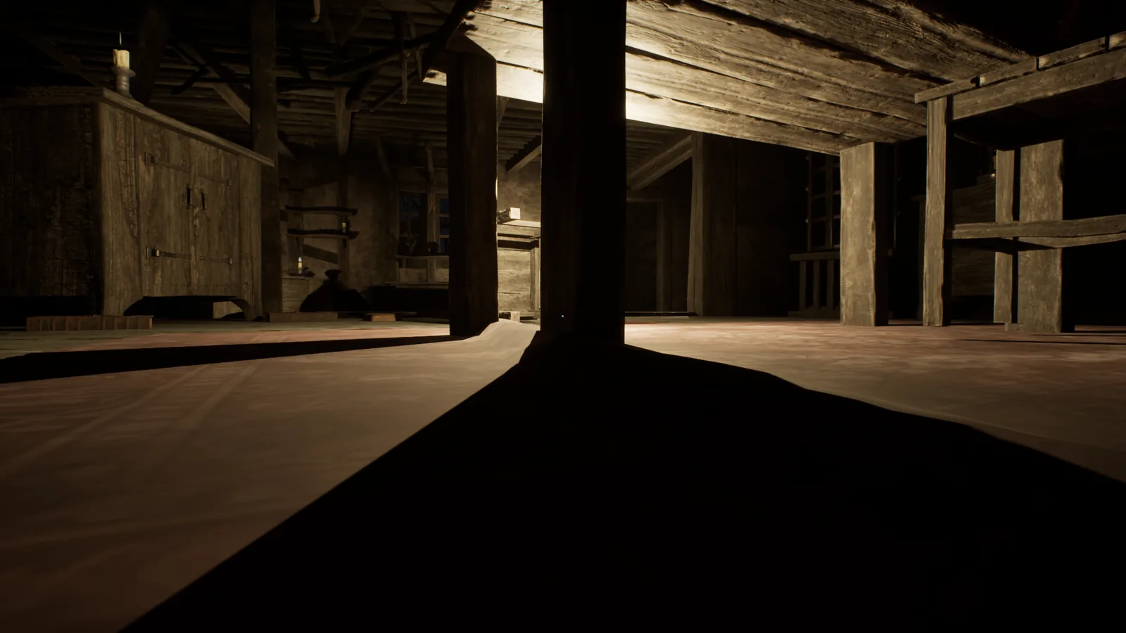 In-game capture: the inside of a timber barn, with hard light cutting across the floorboards